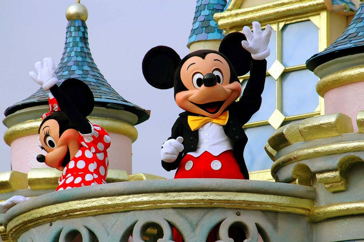 16 Best Disney Cat Names You'll Love 13 mickey and minnie mouse waving on a balcony